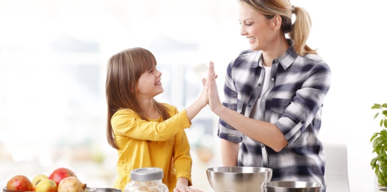 Mother giving high five to daughter