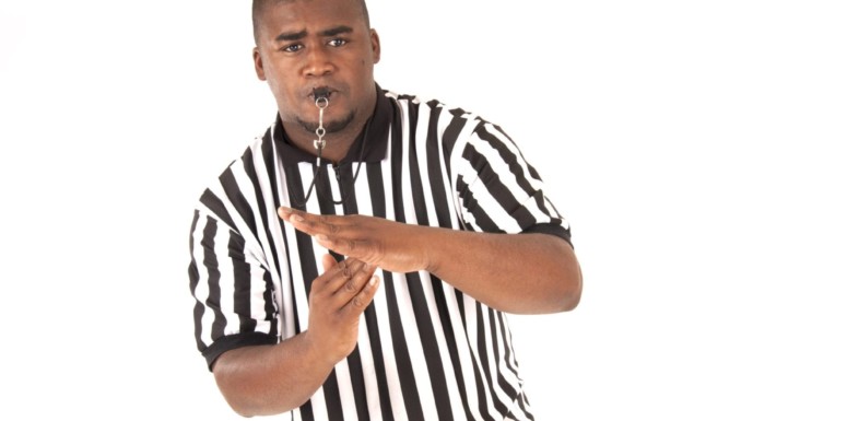 Referee blowing whistle